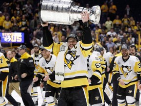 Pittsburgh Penguins' Sidney Crosby celebrates with the Stanley Cup after defeating the Nashville Predators in Game 6 of the NHL hockey Stanley Cup Final in Nashville, Tenn., on June 11, 2017