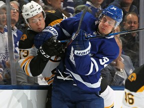 Charlie McAvoy of the Boston Bruins gets slammed by Auston Matthews of the Toronto Maple Leafs during Game 4 at the Air Canada Centre on April 19, 2018
