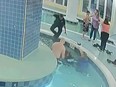 Surveillance video shows bystanders and police officers rescue a boy stuck underwater in a pool at a South Carolina resort.