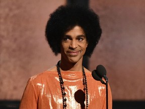 FILE - This Feb. 8, 2015, file photo shows Prince presenting the award for album of the year at the 57th annual Grammy Awards in Los Angeles. A Minnesota doctor accused of illegally prescribing an opioid painkiller for Prince a week before the musician died from a fentanyl overdose has agreed to pay $30,000 to settle a federal civil violation, according to documents made public Thursday. Prince was 57 when he was found alone and unresponsive in an elevator at his Paisley Park estate on April 21, 2016. An autopsy found he died of an accidental overdose of fentanyl.