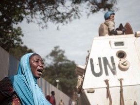 A woman reacts next to UN soldiers as inhabitants of the mainly Muslim PK5 neighbourhood demonstrate in front of the headquarters of MINUSCA, the UN peacekeeping mission in the Central Africa Republic, in Bangui, on April 11, 2018. (FLORENT VERGNES/AFP/Getty Images)