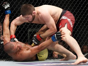 Khabib Nurmagomedov hits Edson Barboza during a lightweight mixed martial arts bout at UFC 219 on Dec. 30, 2017, in Las Vegas