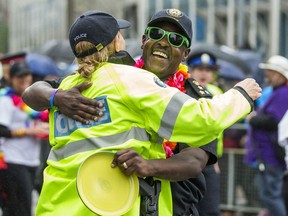 Toronto Police Chief Mark Saunders hugs a police officer during the Toronto Pride Parade in downtown Toronto, Ont. on Sunday June 28, 2015. (Ernest Doroszuk/Toronto Sun)