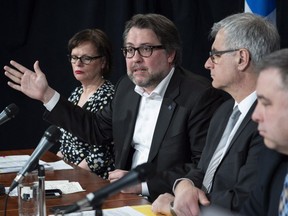 Quebec ministers Lucie Charlebois, David Heurtel, Jean-Marc Fournier and Sébastien Proulx, left to right, discuss the situation involving asylum seekers during a news conference, Monday, April 16, 2018 in Montreal.