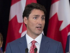 Prime Minister Justin Trudeau, flanked by Laura Albanese, left, Ontario Minister of Citizenship, and Kathleen Weil, Quebec Minister of Immigration, Diversity and Inclusiveness, responds to questions following a meeting of the Intergovernmental Task Force on Irregular Migration Wednesday, August 23, 2017 in Montreal.