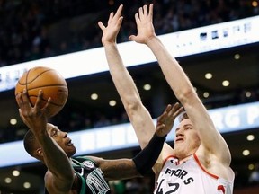 Boston Celtics' Terry Rozier (12) shoots against Toronto Raptors' Jakob Poeltl (42) during the first quarter of an NBA basketball game in Boston, Saturday, March 31, 2018.