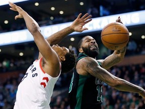 Boston Celtics' Marcus Morris (13) blocks a shot by Toronto Raptors' Kyle Lowry during the fourth quarter of an NBA basketball game in Boston, Saturday, March 31, 2018. The Celtics won 110-99.
