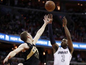 Washington Wizards guard John Wall (2) shoots over Toronto Raptors center Jakob Poeltl during the second half of Game 6 of an NBA basketball first-round playoff series Friday, April 27, 2018, in Washington. The Raptors won 102-92.
