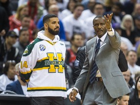Toronto Raptors head coach Dwane Casey and rapper Drake - wearing a Humboldt Broncos jersey - during Eastern Conference Playoff Game 1 first half action against Washington Wizards at the Air Canada in Toronto, Ont. on Saturday April 14, 2018. Ernest Doroszuk/Toronto Sun/Postmedia Network