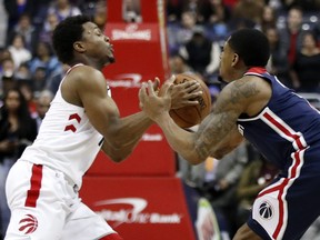 Raptors guard Kyle Lowry, left, and Washington Wizards guard Bradley Beal go for the ball during the second half of  their Feb. 1, 2018 game in Washington. The teams will met in the opening round of the NBA playoffs.  (AP Photo/Alex Brandon)