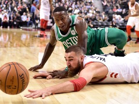 Toronto Raptors centre Jonas Valanciunas and Boston Celtics guard Terry Rozier eye a loose ball during NBA action in Toronto on April 4, 2018