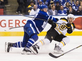 Toronto Maple Leafs Morgan Rielly shoves the Boston Bruins David Pastrnak at the Air Canada Centre last night. (Ernest Doroszuk/Toronto Sun)