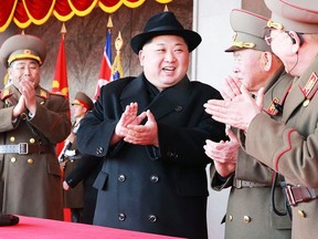 This photo taken on February 8, 2018 and released on February 9, 2018 by North Korea's official Korean Central News Agency (KCNA) shows North Korean leader Kim Jong-Un (C) attending a military parade to mark the 70th anniversary of the Korean People's Army at Kim Il Sung square in Pyongyang.