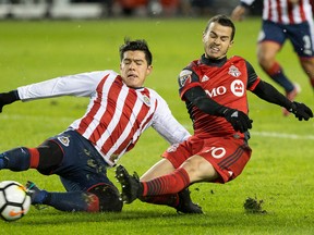 Toronto FC's Sebastian Giovinco gets a shot off at goal under pressure from Guadalajara's Michael Perez during first half CONCACAF Champions League final first leg in Toronto on April 17, 2018