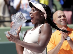 Sloane Stephens holds her trophy after defeating Jelena Ostapenko, of Latvia, in the final at the Miami Open tennis tournament, Saturday, March 31, 2018, in Key Biscayne, Fla. (AP Photo/Lynne Sladky)