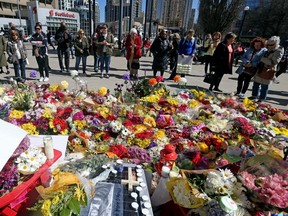 Mourners pay their respects at the memorial for the Yonge St. van attack victims at Mel Lastman Square in Toronto on April 26, 2018.