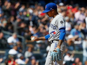 Marcus Stroman of the Toronto Blue Jays looks at the ball as he stands on the mound during the sixth inning against the New York Yankees at Yankee Stadium on April 21, 2018 in the Bronx borough of New York City.  (Jim McIsaac/Getty Images)