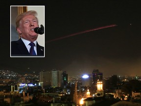 Damascus skies erupt with anti-aircraft fire as the U.S. launches an attack on Syria targeting different parts of the Syrian capital Damascus, Syria, early Saturday, April 14, 2018. Syria's capital has been rocked by loud explosions that lit up the sky with heavy smoke as U.S. President Donald Trump announced airstrikes in retaliation for the country's alleged use of chemical weapons. (AP Photo/Hassan Ammar)