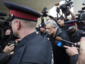 Father of the accused  , Vahe Minassian is escorted out of the 1000 Finch Court by police officers after his son Alek Minassian was charged with 10 counts of first degree & 13 counts of attempted murder on Tuesday April 24, 2018. (Stan Behal/Toronto Sun)