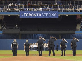 First responders who helped during Monday's deadly van rampage participate in the singing of the national anthem prior to the start of the Blue Jays game against the Boston Red Sox in Toronto on Tuesday April 24, 2018