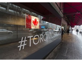 A Canadian flag along with a sign stating #TORONTOSTRONG in the window of the Holt Renfrew department store along Bloor St.W., near Yonge St. in Toronto, Ont. on Wednesday April 25, 2018. Ernest Doroszuk/Toronto Sun/Postmedia Network