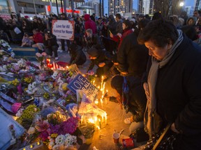 Lighting candles at the memorial after the #TorontoStrong Vigil at Mel Lastman Square in Toronto, Ont. on Sunday April 29, 2018. The event brought people together following the van attack that left 10 people dead. Ernest Doroszuk/Toronto Sun