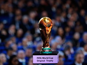 In this Dec. 1, 2017 file photo, the World Cup trophy is placed on display during the 2018 soccer World Cup draw in the Kremlin in Moscow