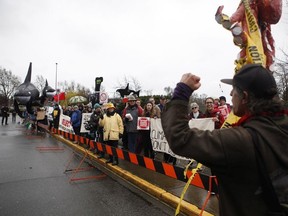 Protesters chant as they wait for Prime Minister Justin Trudeau's arrival to meet with members of the Canadian Coast Guard to discuss marine safety and spill prevention, in Victoria on Thursday, April 5, 2018.