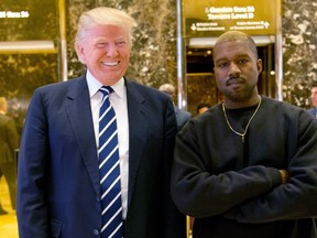 In this Dec. 13, 2016, file photo, then-President-elect Donald Trump and Kanye West pose for a picture in the lobby of Trump Tower in New York. (AP Photo/Seth Wenig, File)