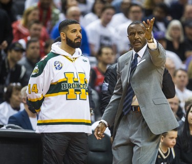 Toronto Raptors head coach Dwane Casey and rapper Drake - wearing a Humboldt Broncos jersey - during Eastern Conference Playoff Game 1 first half action against Washington Wizards at the Air Canada in Toronto, Ont. on Saturday April 14, 2018. Ernest Doroszuk/Toronto Sun/Postmedia Network