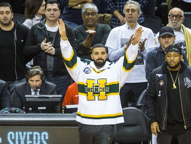 Rapper Drake - wearing a Humboldt Broncos jersey - raises his arms in the final seconds of game action with Toronto Raptors winning in Eastern Conference Playoff Game 1  against Washington Wizards at the Air Canada in Toronto, Ont. on Saturday April 14, 2018. Ernest Doroszuk/Toronto Sun/Postmedia Network