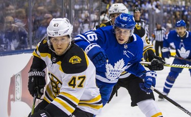 Toronto Maple Leafs Mitch Marner during first period Round 1 Game 3 action against Boston Bruins Torey Krug (front) and Brad Marchand at the Air Canada Centre in Toronto, Ont. on Monday April 16, 2018. Ernest Doroszuk/Toronto Sun/Postmedia Network