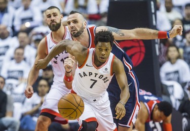 Toronto Raptors Kyle Lowry (front) and Jonas Valanciunas during 1st half action against the Washington Wizards Marcin Gortat  in Game 2 of the Eastern Conference - First Round at the Air Canada Centre in Toronto, Ont. on Tuesday April 17, 2018. Ernest Doroszuk/Toronto Sun/Postmedia Network