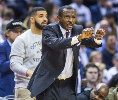 Toronto Raptors head coach Dwane Casey - behind him is rapper Drake -  during 2nd half action against the Washington Wizards in Game 2 of the Eastern Conference - First Round at the Air Canada Centre in Toronto, Ont. on Tuesday April 17, 2018. Ernest Doroszuk/Toronto Sun/Postmedia Network
