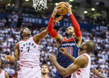 Toronto Raptors Kyle Lowry (left) and Serge Ibaka during 2nd half action against the Washington Wizards Mike Scott in Game 2 of the Eastern Conference - First Round at the Air Canada Centre in Toronto, Ont. on Tuesday April 17, 2018. Ernest Doroszuk/Toronto Sun/Postmedia Network