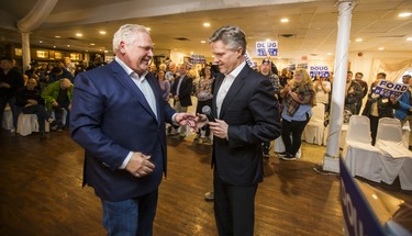 Ontario PC leader Doug Ford (left) receives the microphone from Ontario PC candidate Rod Phillips at a campaign rally at La Roya Banquet Hall in Ajax, Ont. on Wednesday April 18, 2018. Ernest Doroszuk/Toronto Sun/Postmedia Network