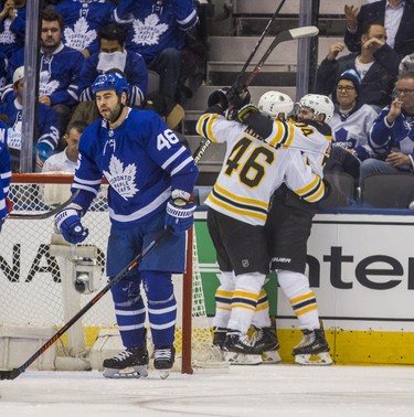 Toronto Maple Leafs Roman Polak reacts as Boston Bruins David Krejci (back left) and Jake DeBrusk celebrate a goal during third period playoff action in Round 1 Game 4 at the Air Canada Centre in Toronto, Ont. on Thursday April 19, 2018. Ernest Doroszuk/Toronto Sun/Postmedia Network