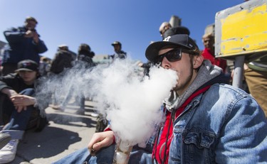 Sanzo, exhales after taking a hit from a bong during the cannabis themed gathering at 420 Toronto 2018 at Nathan Phillips Square in Toronto, Ont.  on Friday April 20, 2018. Ernest Doroszuk/Toronto Sun/Postmedia Network