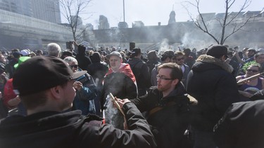 Smoke fills the air at a cannabis themed gathering at 420 Toronto 2018 at Nathan Phillips Square in Toronto, Ont.  on Friday April 20, 2018. Ernest Doroszuk/Toronto Sun/Postmedia Network