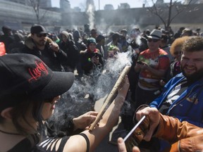 A joint containing 56 grams of marijuana is passed around at a cannabis themed gathering at 420 Toronto 2018 at Nathan Phillips Square in Toronto, Ont.  on Friday April 20, 2018. Ernest Doroszuk/Toronto Sun/Postmedia Network