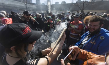 A joint containing 56 grams of marijuana is passed around at a cannabis themed gathering at 420 Toronto 2018 at Nathan Phillips Square in Toronto, Ont.  on Friday April 20, 2018. Ernest Doroszuk/Toronto Sun/Postmedia Network