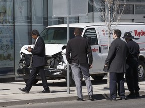 Officials examine a van after pedestrians were run down on Yonge St. in Toronto on Monday April 23, 2018. Craig Robertson/Toronto Sun/Postmedia Network