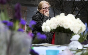 A steady stream of people stop to drop off flowers and read handwritten notes at a memorial wall at Yonge St and Finch Ave. on Wednesday April 25, 2018 after the deadly van attack in North York.Veronica Henri/Toronto Sun/Postmedia Network