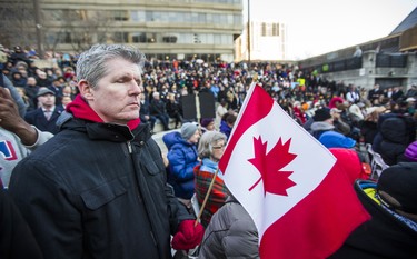 Wayne Adam holding a Canadian flag during the #TorontoStrong Vigil at Mel Lastman Square in Toronto, Ont. on Sunday April 29, 2018. The event brought people together following the van attack that left 10 people dead. Ernest Doroszuk/Toronto Sun/Postmedia Network