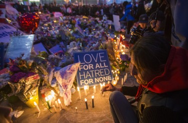 Lighting candles in at the memorial to the 10 victims of the fatal van attack,  following the #TorontoStrong Vigil at Mel Lastman Square in Toronto, Ont. on Sunday April 29, 2018. The event brought people together following the van attack that left 10 people dead. Ernest Doroszuk/Toronto Sun/Postmedia Network