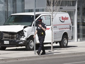 A damaged white Ryder van is seen after the attack that killed 10 pedestrians on April 23, 2018 in north Toronto.