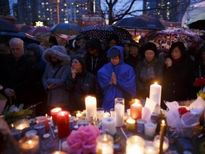 People pray for the victims of the mass killing at a vigil on April 24, 2018.