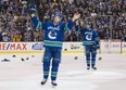 Daniel Sedin and Henrik Sedin of the Vancouver Canucks salute the fans after playing in their final home game of their career against the Arizona Coyotes in NHL action on April, 5, 2018