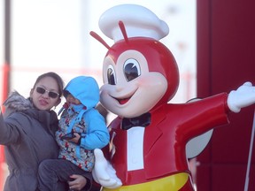 A woman and child take a photo with the Jollibee mascot.  (Postmedia Network files)