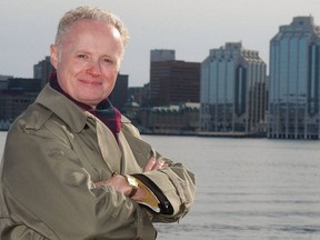 Brian Lee Crowley on the shores of Dartmouth with the Halifax skyline in the distance.